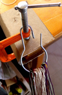 Mounting loops onto a ring for finger loop braiding