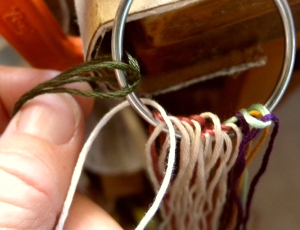 Mounting loops onto a ring for fingerloop braiding