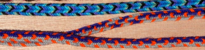 7-loop wool flat braids, one with color-linking (finger loop braiding)