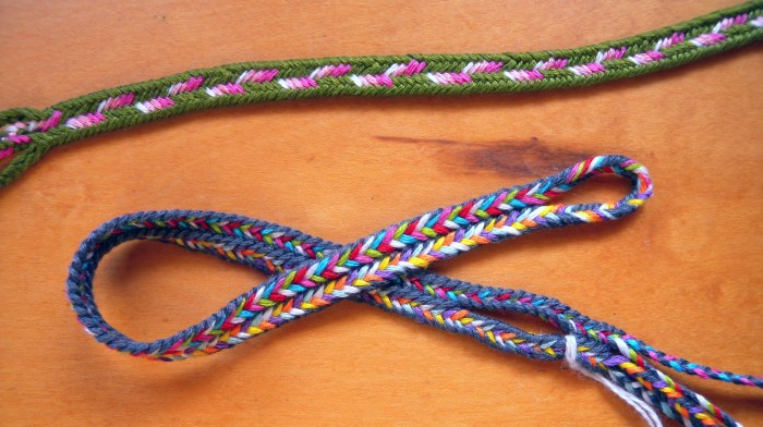 two 9-loop flat fingerloop braids having color patterns that require linking. Loop manipulation/ loop braiding