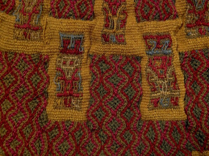 precolumbian textile pendant, braided and woven fabric