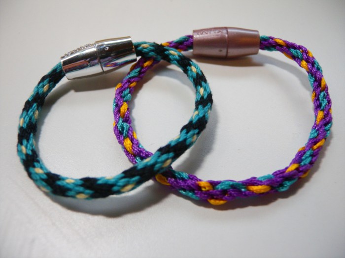 Bracelets made on Spin Master Cool Maker KumiKreator; left bracelet made with size 3 cotton crochet thread, right bracelet made with Kumikreator synthetic thread. Clasps are the two colors of plastic clasps that come with the machine.