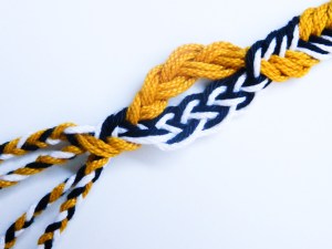 Loop at bottom of a Lace Broad Party, made with 4 bicolor black and white loops, and 3 gold loops. loopbraider.com